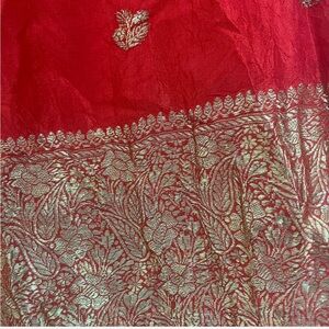 Red and gold silk scarf with floral detailing. Dry clean only. 58’x 19’